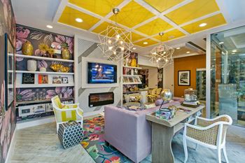 a living room with a table and chairs and a television